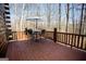 Wooden patio with table and chairs surrounded by a natural wooded area at 1225 Pitts Chapel E, Newborn, GA 30056