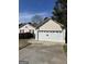 View of the garage with a driveway and partial view of the house at 413 Remington Ct, Villa Rica, GA 30180