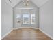 Bright dining room featuring a bay window, hardwood floors, and modern chandelier at 835 Betsy Ross Trail, Hampton, GA 30228