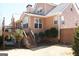 Back exterior view of the home featuring a wood deck, staircase and mature trees at 2920 Stanway Ave, Douglasville, GA 30135