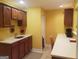 Cozy kitchenette featuring dark wood cabinetry, laminate countertops and stainless steel sink at 2920 Stanway Ave, Douglasville, GA 30135