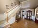 Inviting foyer features hardwood floors, staircase, and decorative wainscoting, creating a welcoming entrance at 6302 Manassas Nw Pass, Acworth, GA 30101