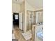 Tiled bathroom featuring a glass shower with neutral color tones and an open doorway to the bedroom at 9444 Lantana Trl, Jonesboro, GA 30238