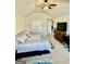 Bedroom featuring a queen bed, ceiling fan and a workspace in the corner at 9444 Lantana Trail, Jonesboro, GA 30238