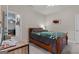 Bedroom showcasing a wooden desk and a queen-sized bed with a green blanket at 460 Carrie Kathleen Ter, Carrollton, GA 30116