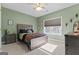 Bedroom with soft green walls, carpeted floors, and light-filtering window shades at 460 Carrie Kathleen Ter, Carrollton, GA 30116