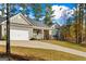A single-Gathering home featuring a two-car garage, stone accents, and a charming front porch at 460 Carrie Kathleen Ter, Carrollton, GA 30116
