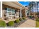 Inviting front porch with rocking chairs, decorative stone, and well-maintained landscaping at 460 Carrie Kathleen Ter, Carrollton, GA 30116