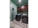 The laundry room includes dark cabinets, a washer, a dryer, and an ironing board at 460 Carrie Kathleen Ter, Carrollton, GA 30116