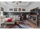 Comfortable living room featuring a sectional sofa, stylish decor, and a TV with a wooden entertainment center at 460 Carrie Kathleen Ter, Carrollton, GA 30116