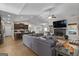 Open-concept living room with a large sectional sofa, fireplace, and seamless transition to the modern kitchen at 460 Carrie Kathleen Ter, Carrollton, GA 30116
