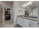 A spacious main bathroom provides double sinks, granite countertops and tiled floors at 460 Carrie Kathleen Ter, Carrollton, GA 30116