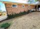 Brick wall of home with ivy and stone path along an outdoor space at 107 Cannongate Cir, Sharpsburg, GA 30277