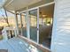 Access to a sunroom with tile floor, large windows, and ceiling fan from a wood patio at 107 Cannongate Cir, Sharpsburg, GA 30277