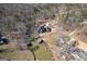 Aerial view of a well-manicured property with a large home, boat docks, and mature trees at 50 Birch Rd, Covington, GA 30014