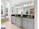 Bright bathroom featuring dual vanities with granite countertops, modern lighting, and tile flooring at 50 Birch Rd, Covington, GA 30014