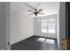 Bright bedroom featuring a ceiling fan, large window, and gray wood-look flooring at 70 Willow Bend Nw Dr, Cartersville, GA 30121