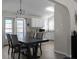 Dining area with a view of the bright kitchen and access to the patio through glass doors at 70 Willow Bend Nw Dr, Cartersville, GA 30121