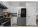 Modern kitchen with stainless steel refrigerator, granite countertops, and white cabinets at 70 Willow Bend Nw Dr, Cartersville, GA 30121