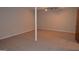 Spacious carpeted basement with support beam and lighting at 5475 Pepperwood Ct, Stone Mountain, GA 30087