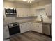 Well-lit kitchen features stainless steel appliances, white cabinets, and granite countertops at 5475 Pepperwood Ct, Stone Mountain, GA 30087