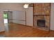 Open-concept living room featuring a stone fireplace and access to a patio at 5475 Pepperwood Ct, Stone Mountain, GA 30087