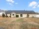 Backyard featuring a large lawn, mature plantings and slider access to the home's interior at 12 Bonnie Glen Ln, Hampton, GA 30228