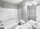 A bathroom featuring a white tub, toilet, and vanity with modern fixtures at 12 Bonnie Glen Ln, Hampton, GA 30228