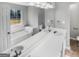 Well-lit bathroom featuring dual sinks, a soaking tub, and large vanity mirror at 12 Bonnie Glen Ln, Hampton, GA 30228