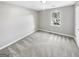 A bright bedroom with neutral carpet and paint, featuring a window that lets in plenty of natural light at 12 Bonnie Glen Ln, Hampton, GA 30228