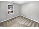 Neutral bedroom featuring large window, plush neutral toned carpet and soft gray walls at 12 Bonnie Glen Ln, Hampton, GA 30228