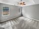 A spacious bedroom with tray ceiling and two windows, offering ample natural light at 12 Bonnie Glen Ln, Hampton, GA 30228