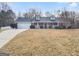 Charming one story brick home with a well manicured lawn, two dormers, and an attached two car garage at 12 Bonnie Glen Ln, Hampton, GA 30228