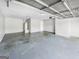 A spacious garage with concrete floor and a visible water heater at 12 Bonnie Glen Ln, Hampton, GA 30228