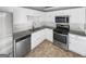 Kitchen with white cabinets, stainless appliances and granite countertops at 12 Bonnie Glen Ln, Hampton, GA 30228
