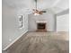Living room featuring vaulted ceilings, a cozy fireplace, and neutral-toned carpet at 12 Bonnie Glen Ln, Hampton, GA 30228