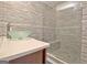 Modern bathroom with a glass shower, glass sink, and gray accent tiles at 747 S Fairfield Dr, Peachtree City, GA 30269