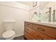 Cozy bathroom featuring a wooden vanity, a vessel sink, and updated fixtures at 747 S Fairfield Dr, Peachtree City, GA 30269