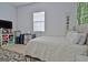 Comfortable bedroom with a plush bed, natural light, and ample space for relaxation at 747 S Fairfield Dr, Peachtree City, GA 30269