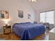 Bright bedroom featuring wood floors, vaulted ceilings, and stylish decor at 747 S Fairfield Dr, Peachtree City, GA 30269