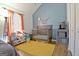 Bright bedroom featuring a crib, colorful rug, and vaulted ceilings at 747 S Fairfield Dr, Peachtree City, GA 30269