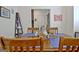 Cozy dining room with wood table set with blue mats and a view of the entryway at 747 S Fairfield Dr, Peachtree City, GA 30269