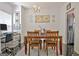 Bright dining area with a chandelier, and stainless steel refrigerator nearby at 747 S Fairfield Dr, Peachtree City, GA 30269