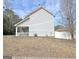 Side view of the home shows white vinyl siding, a covered porch, and a well-maintained yard at 747 S Fairfield Dr, Peachtree City, GA 30269