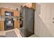 Functional kitchen featuring wooden cabinets, black appliances, and an exterior door at 747 S Fairfield Dr, Peachtree City, GA 30269