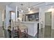 Modern kitchen with sleek black cabinets, stainless steel appliances, and breakfast bar at 747 S Fairfield Dr, Peachtree City, GA 30269