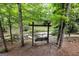 Scenic backyard featuring a swing set beside a small creek surrounded by lush trees at 4421 Paradise Cir, Vinings, GA 30339