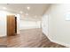 Finished basement with wood-look floors, recessed lighting, and a door with rustic wood trim at 4421 Paradise Cir, Vinings, GA 30339