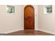 Basement entrance featuring an arched wood door flanked by two square windows with white trim at 4421 Paradise Cir, Vinings, GA 30339