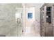 Luxurious bathroom with a glass shower, marble accents, and custom storage cabinet at 4421 Paradise Cir, Vinings, GA 30339